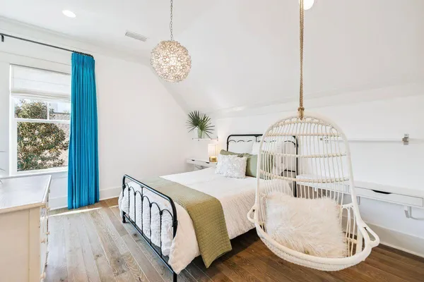 a bedroom with a bed and a potted plant