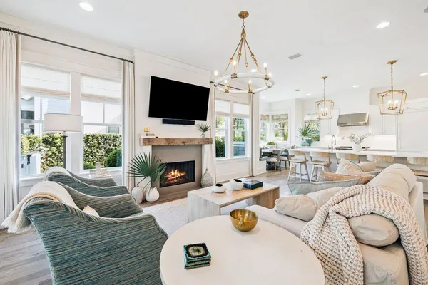 a large white kitchen with a large window and stainless steel appliances