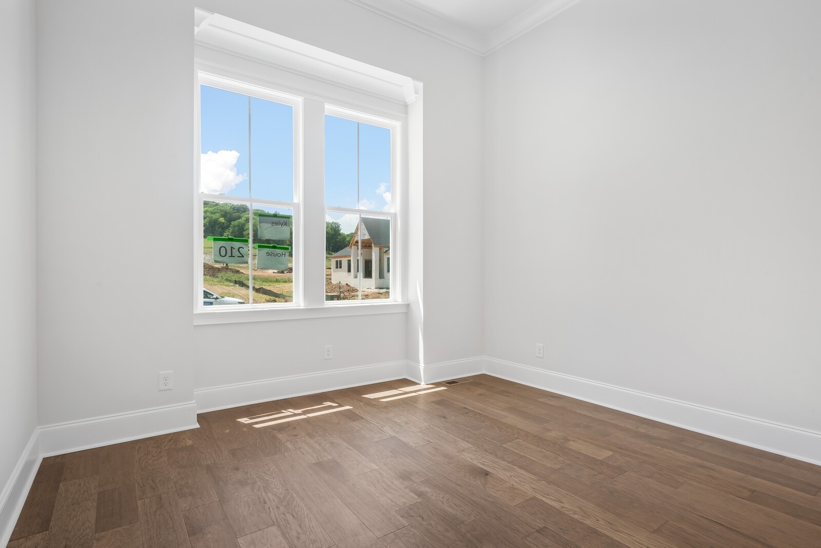 7244 Murrel Drive Franklin, TN 37064 - Photo 12 of 57 an empty room with wooden floor and windows