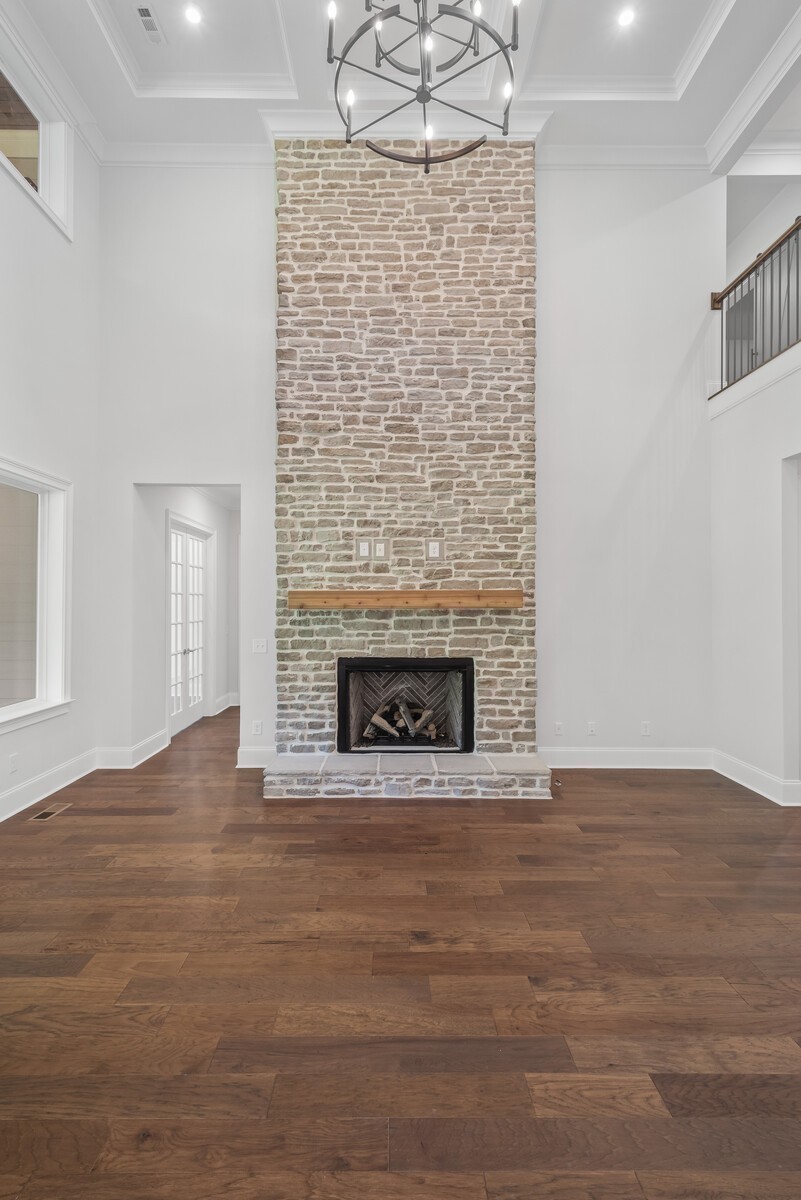 7244 Murrel Drive Franklin, TN 37064 - Photo 15 of 57 a view of an empty room with wooden floor fireplace and a window