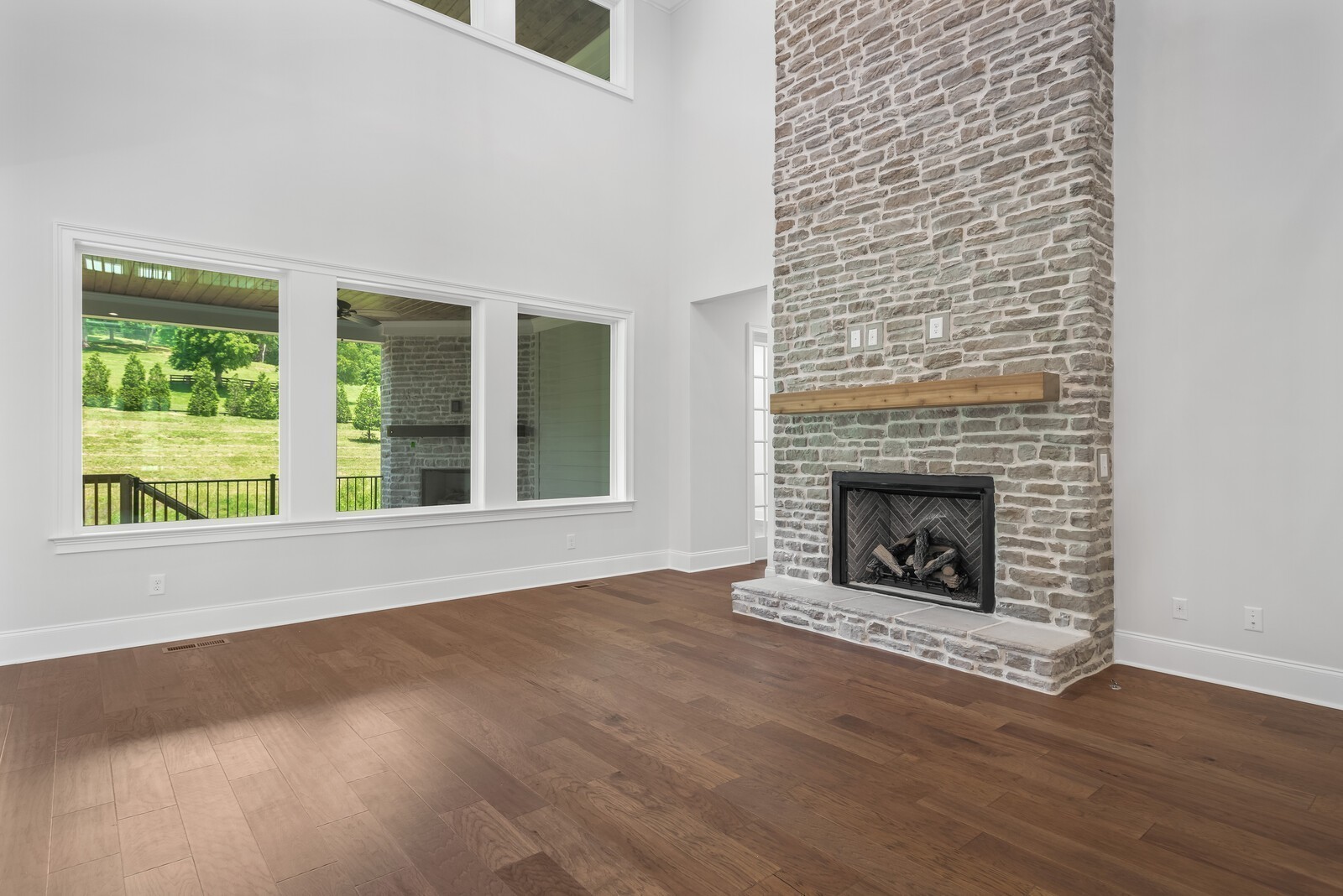 7244 Murrel Drive Franklin, TN 37064 - Photo 16 of 57 a view of an empty room with wooden floor fireplace and a window