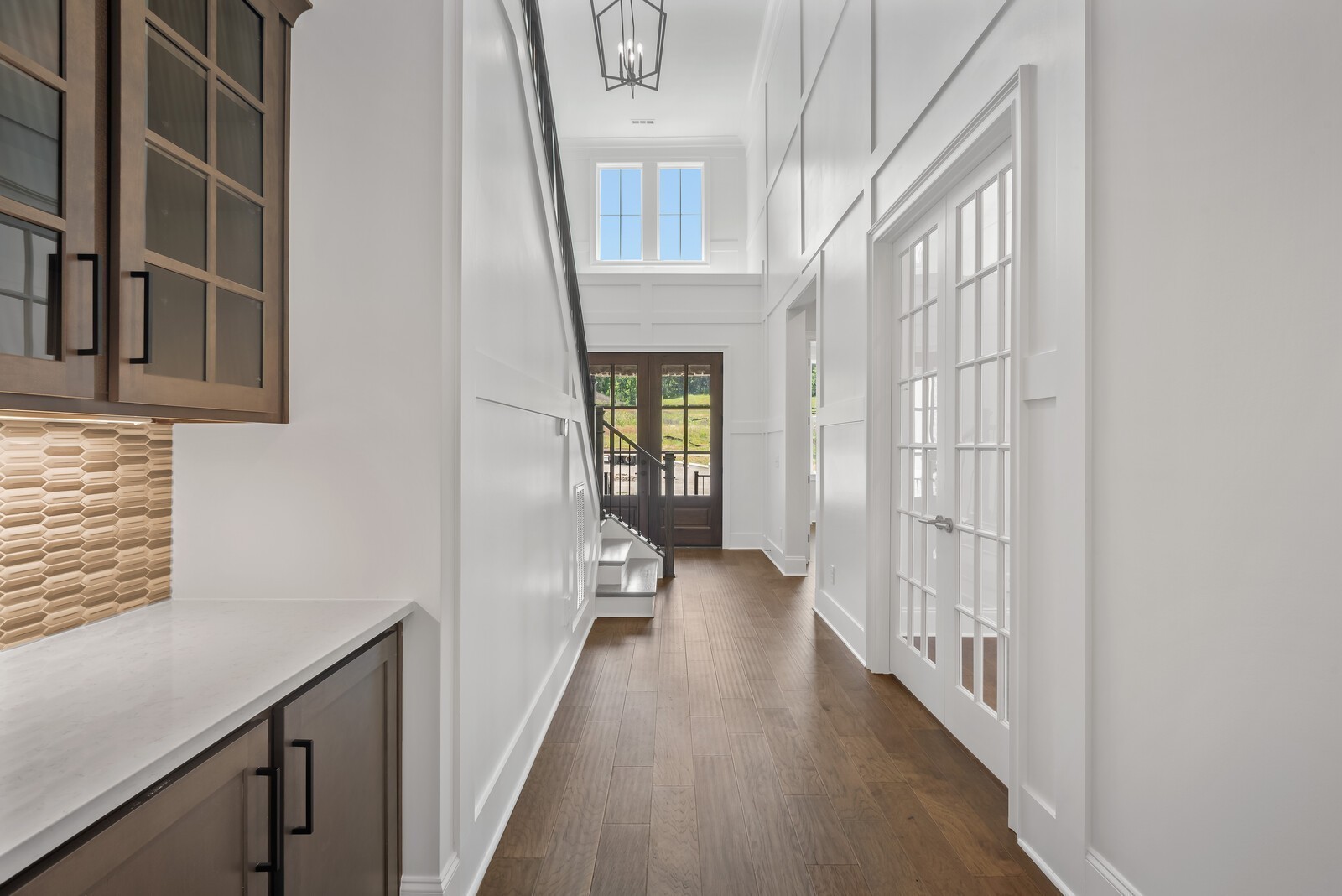 7244 Murrel Drive Franklin, TN 37064 - Photo 7 of 57 a view of a hallway with wooden floor and staircase