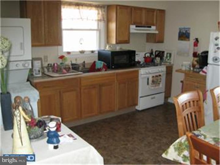 605-607 Filmore Street Riverside, NJ 08075 - Photo 4 of 7 a kitchen with sink refrigerator and window