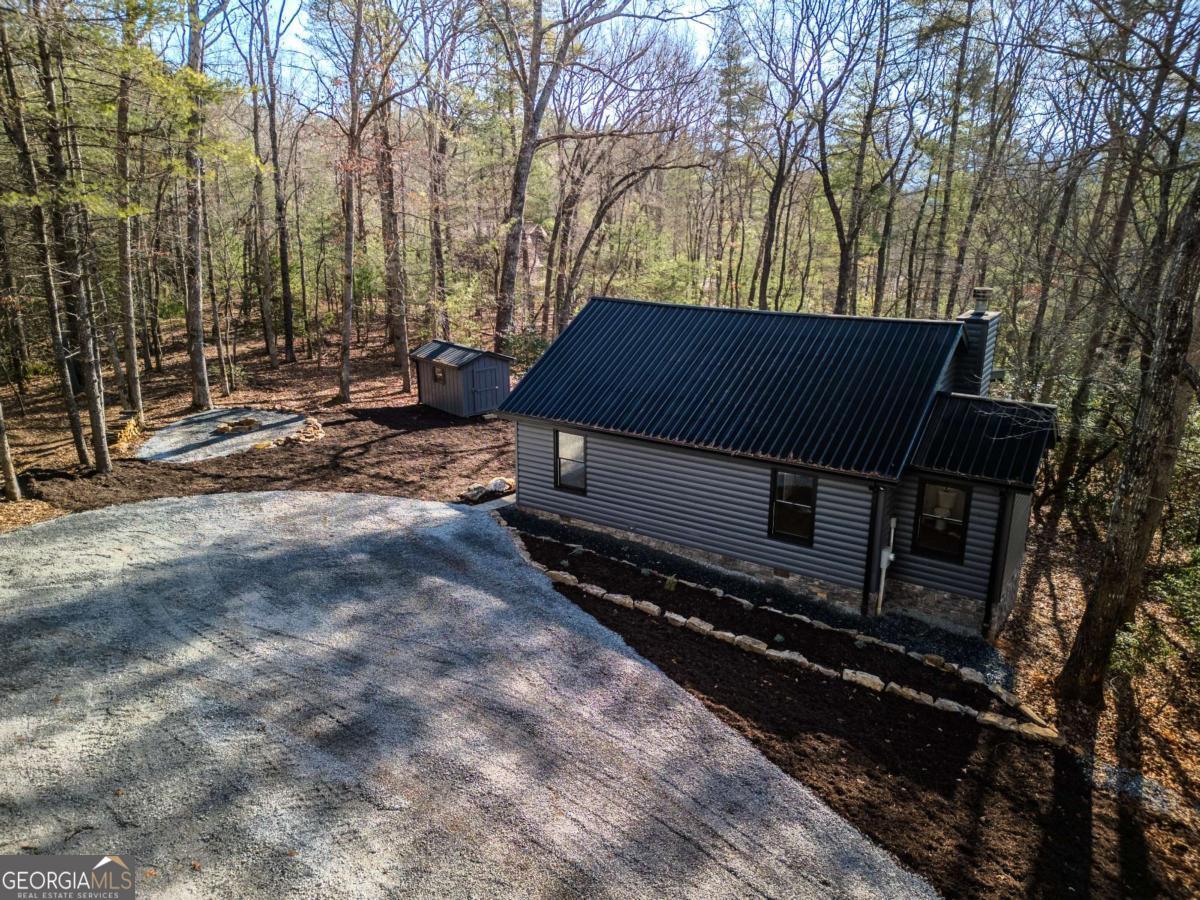 292 Wits End Way Cherry Log, GA 30522 - Photo 15 of 32 a backyard of a house with trees and outdoor space