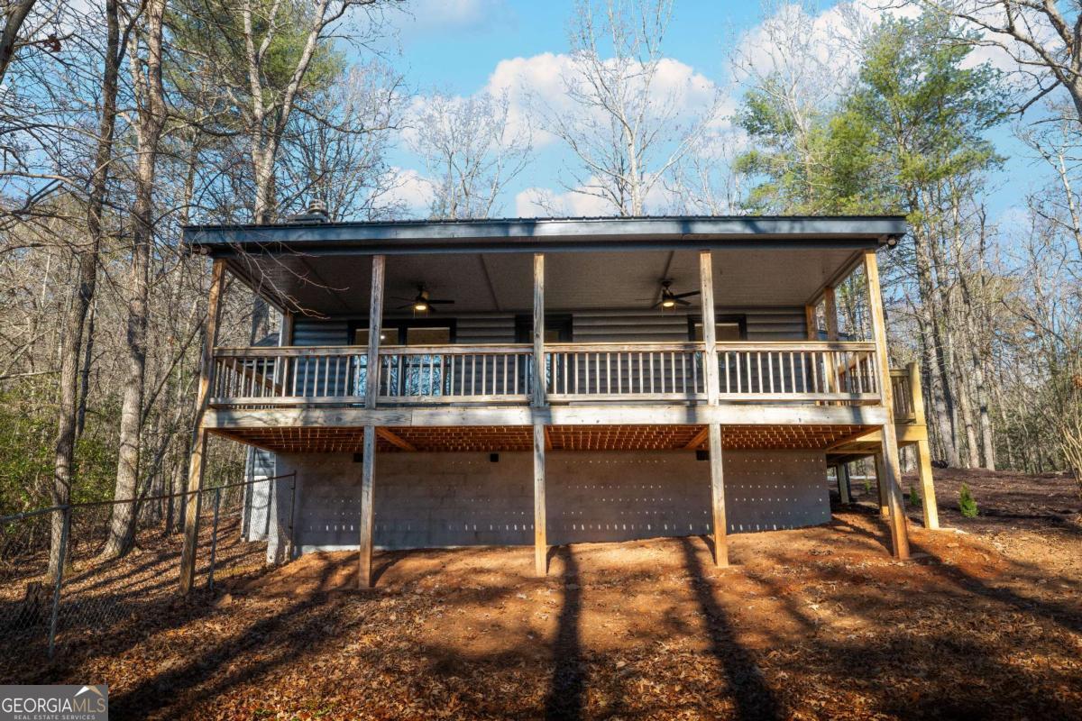 292 Wits End Way Cherry Log, GA 30522 - Photo 28 of 32 a view of house with wooden deck and backyard