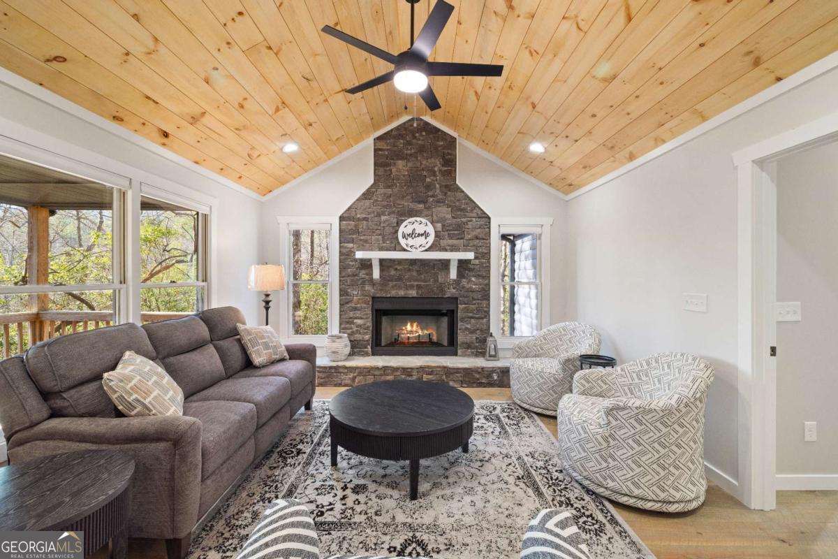 292 Wits End Way Cherry Log, GA 30522 - Photo 5 of 32 a living room with furniture a fireplace and a chandelier