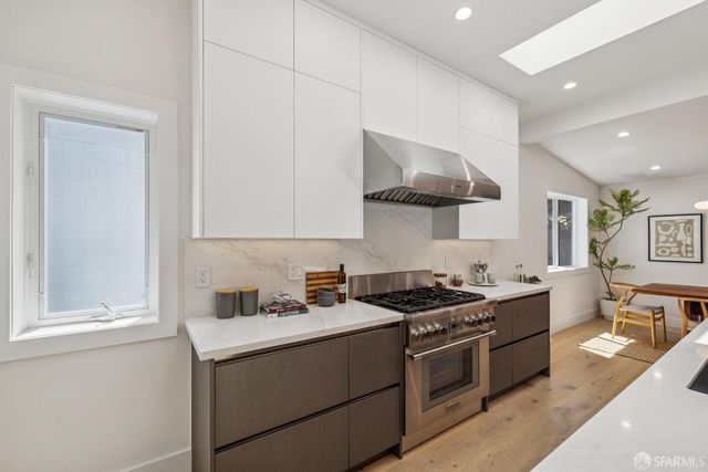 a kitchen with a stove and a clock