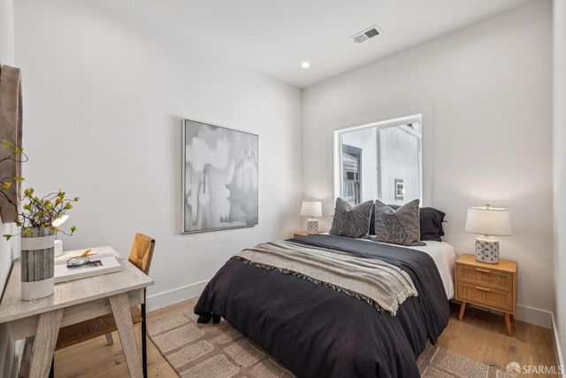 a bedroom with a large bed and a dresser