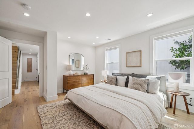 a kitchen with stainless steel appliances granite countertop a stove a sink a refrigerator and chairs