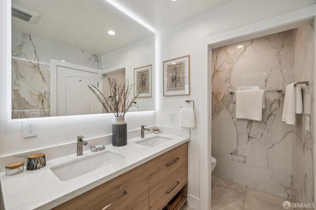a living room with furniture and a mirror