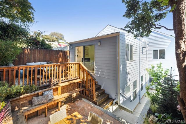 a view of a room with furniture and wooden floor