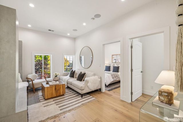 a living room with furniture a lamp and a large window