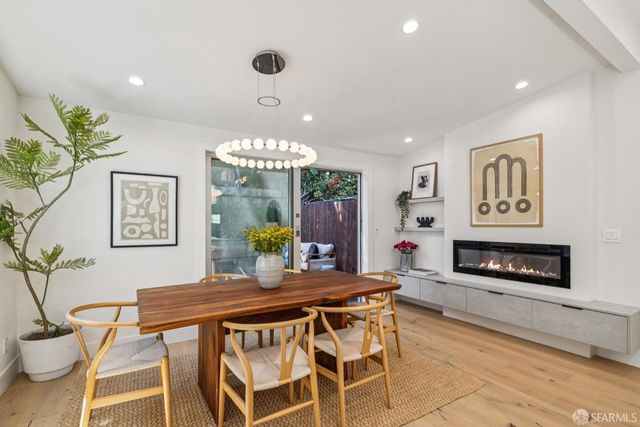 a dining room with furniture and wooden floor