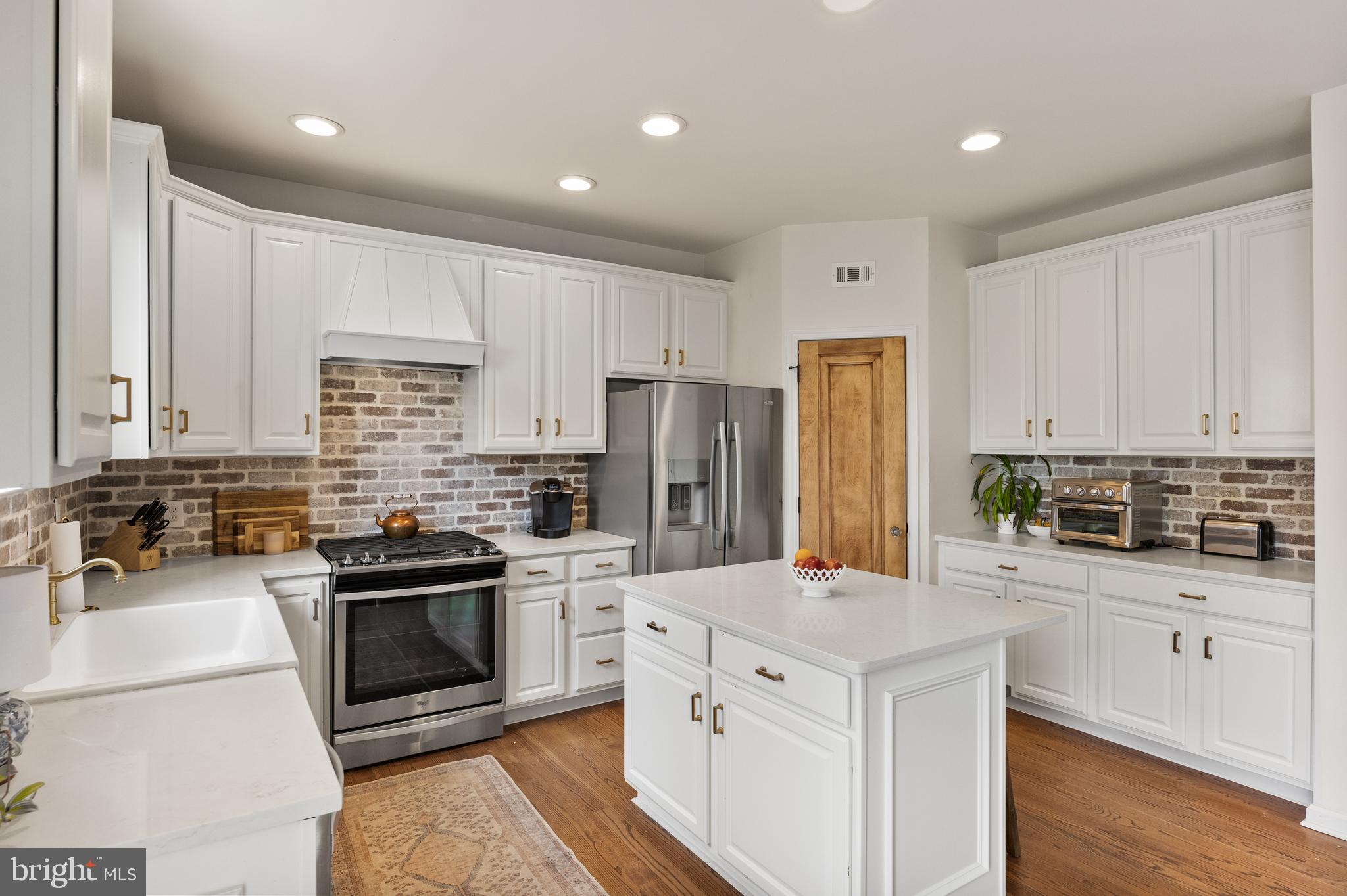 6 Augusta Drive Westampton, NJ 08060 - Photo 7 of 31 a kitchen with white cabinets and stainless steel appliances