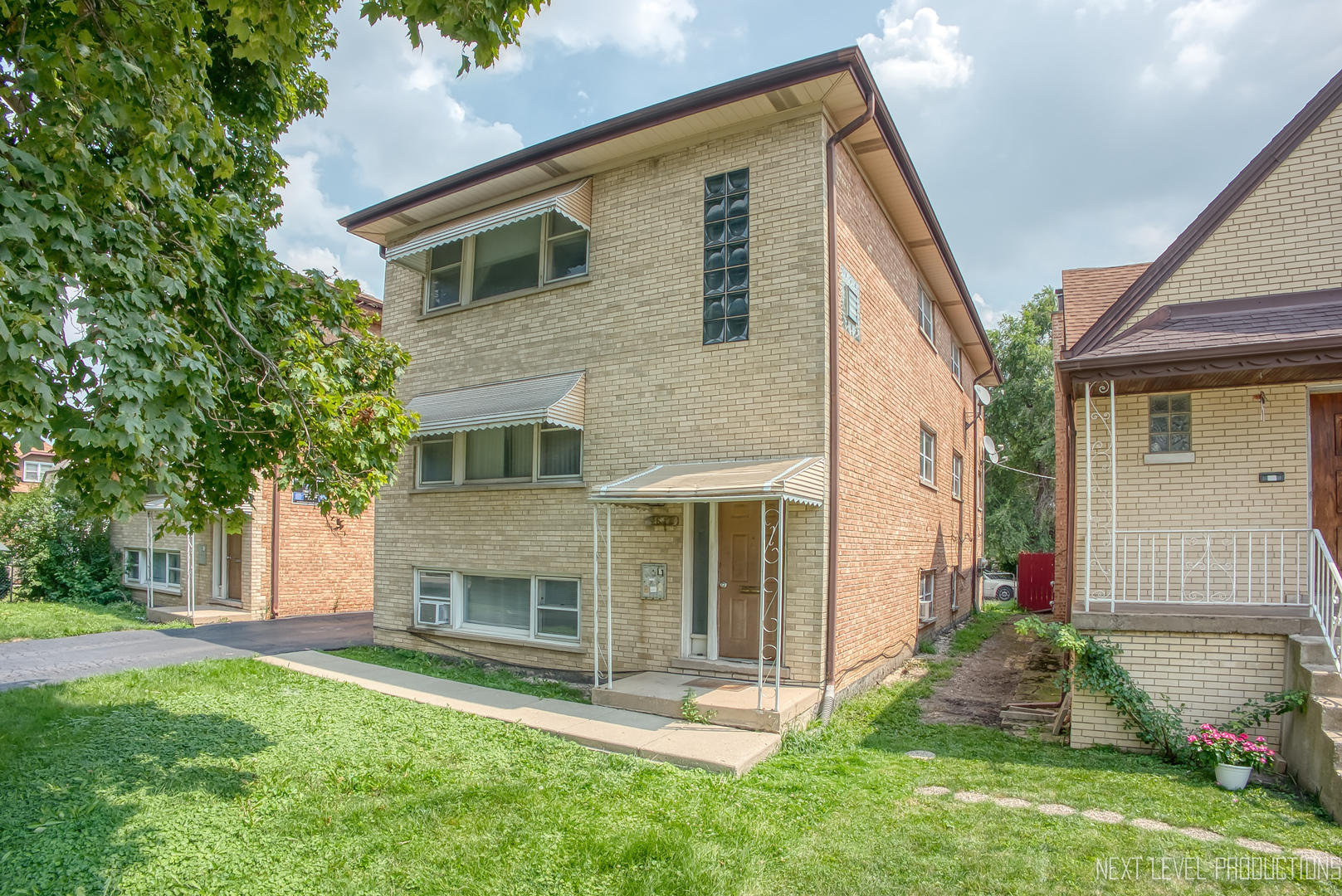 1617 35th Avenue Melrose Park, IL 60160 - Photo 1 of 38 a front view of a house with a yard and garage