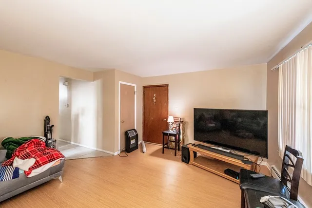 a bedroom with furniture and a flat screen tv