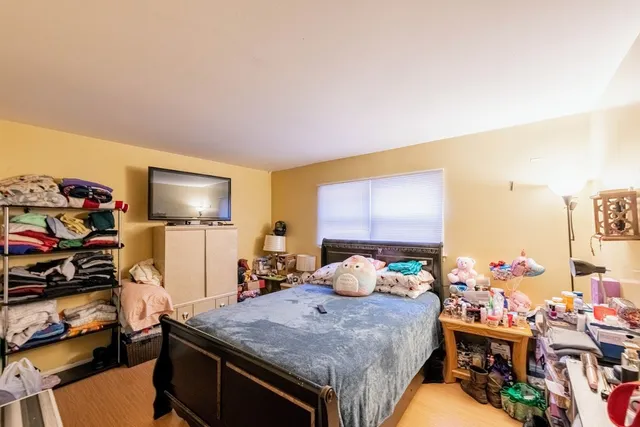 a bedroom with a bed and a flat screen tv