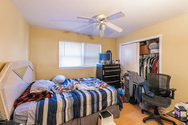 a bedroom with a bed and a book shelf