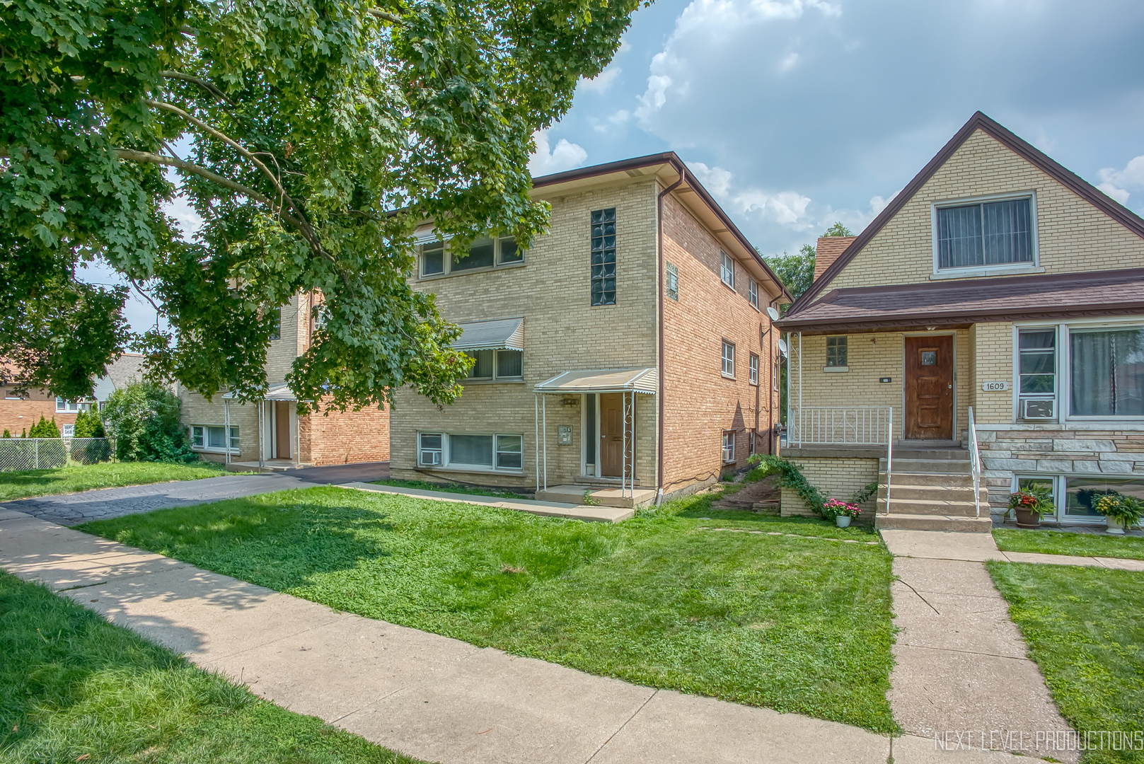 1617 35th Avenue Melrose Park, IL 60160 - Photo 2 of 38 a front view of a house with a yard and green space