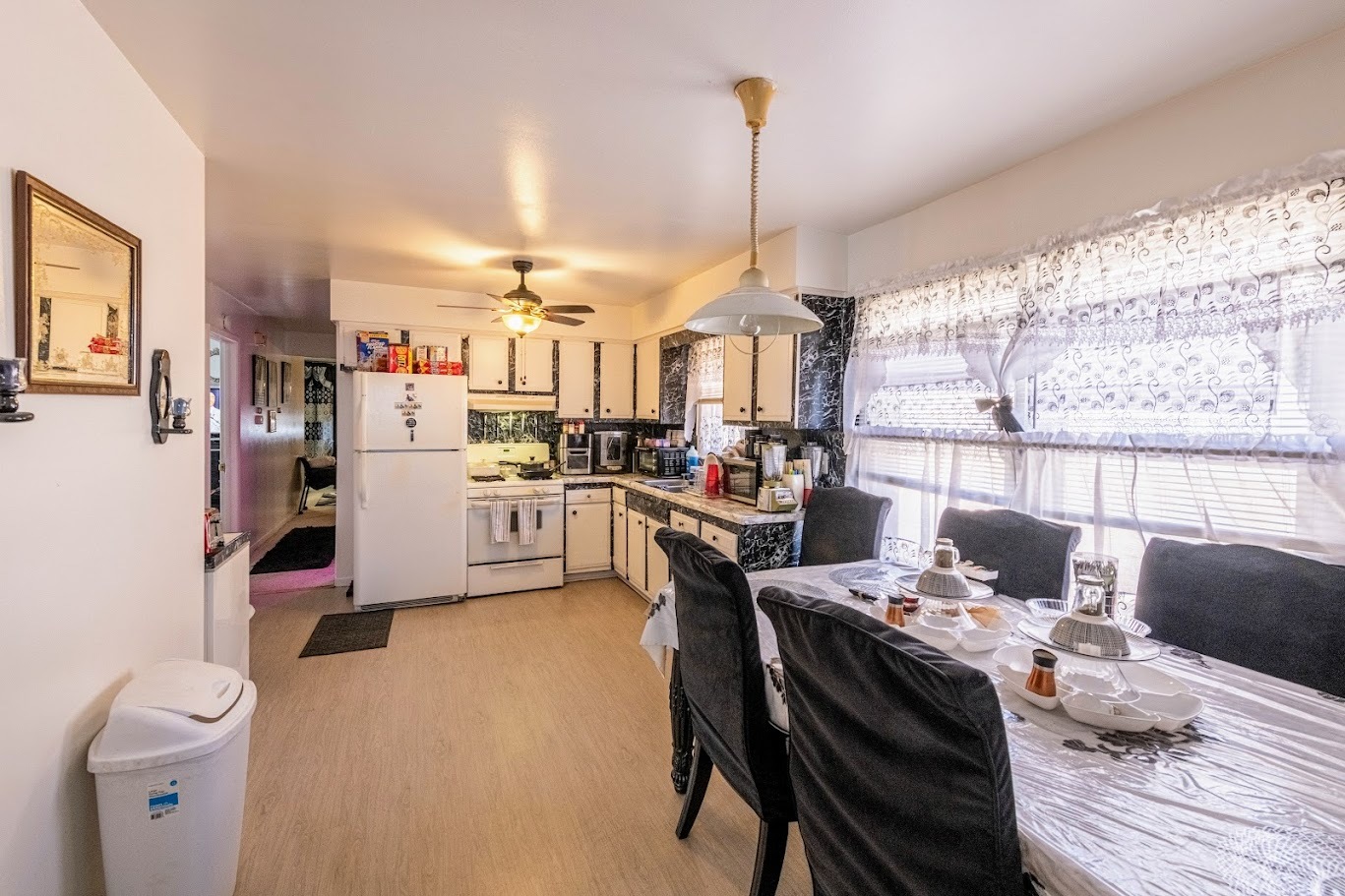 1617 35th Avenue Melrose Park, IL 60160 - Photo 23 of 38 a open kitchen with stainless steel appliances kitchen island granite countertop a stove a sink dishwasher and a dining table with cabinets