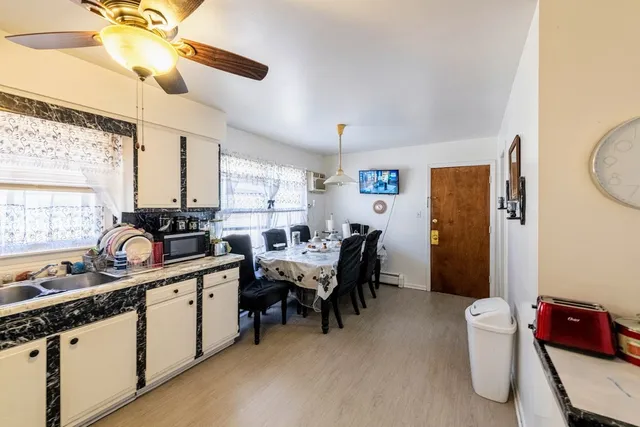 a bedroom with a bed and large windows