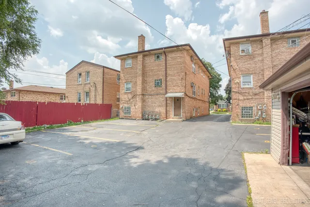 a couple of cars parked in front of a house