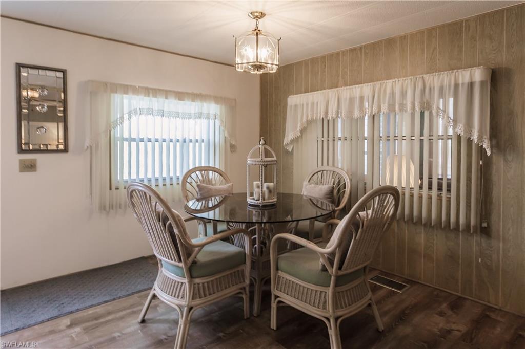 10100 Burnt Store Road, Unit 104 Punta Gorda, FL 33950 - Photo 17 of 46 Dining space with a drop light and and luxury vinyl plank flooring