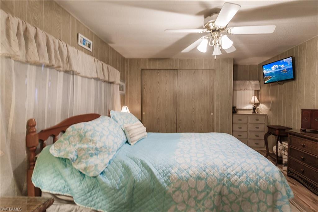 10100 Burnt Store Road, Unit 104 Punta Gorda, FL 33950 - Photo 20 of 46 Bedroom oasis with a closet, ceiling fan, and light laminate / wood-style floors