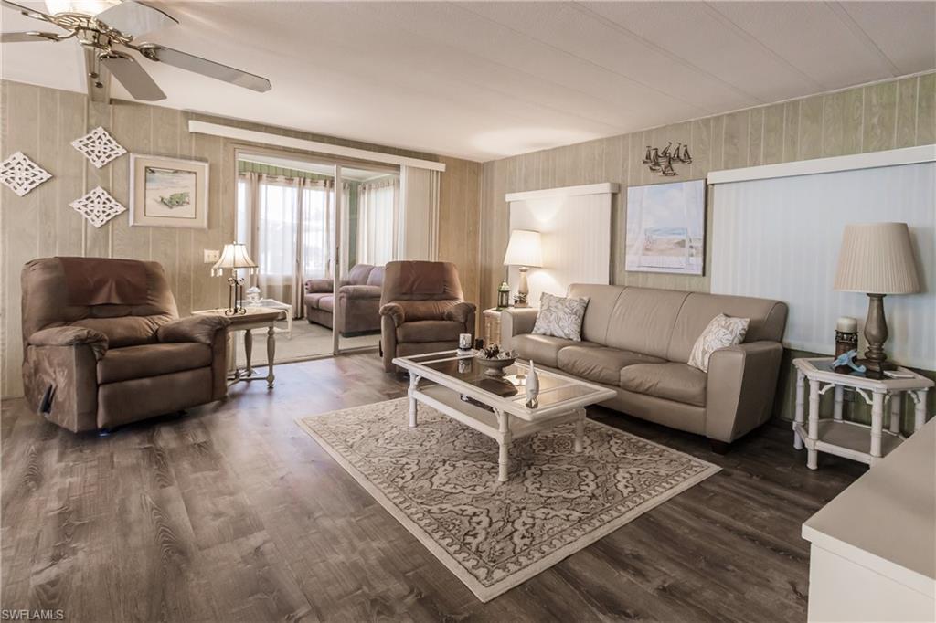 Living room with ceiling fan and luxury vinyl plank flooring