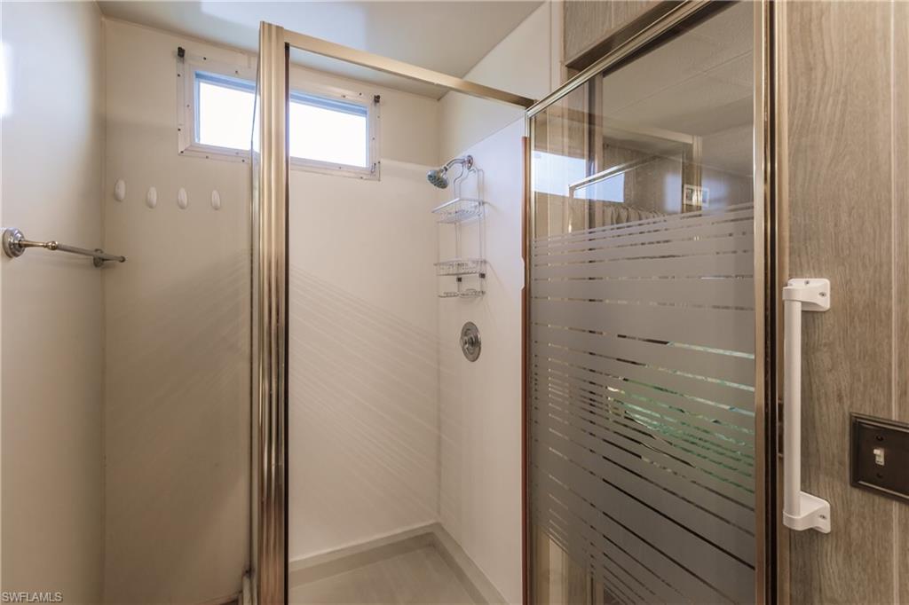 10100 Burnt Store Road, Unit 104 Punta Gorda, FL 33950 - Photo 22 of 46 Bathroom featuring an all glass, walk-in shower
