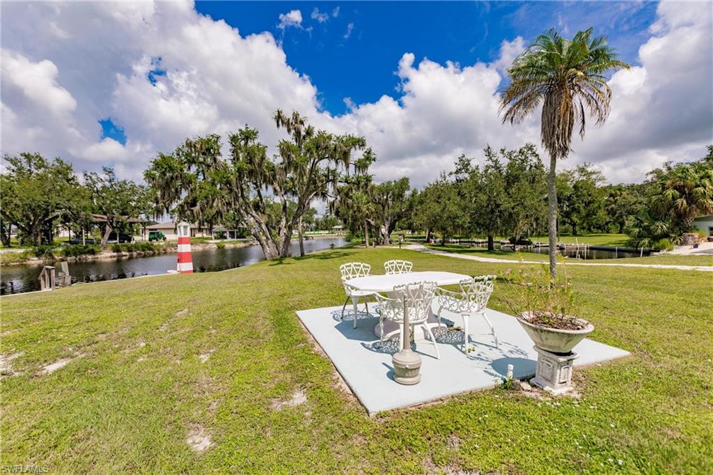 10100 Burnt Store Road, Unit 104 Punta Gorda, FL 33950 - Photo 31 of 46 View of waterside picnic featuring a water view and a patio
