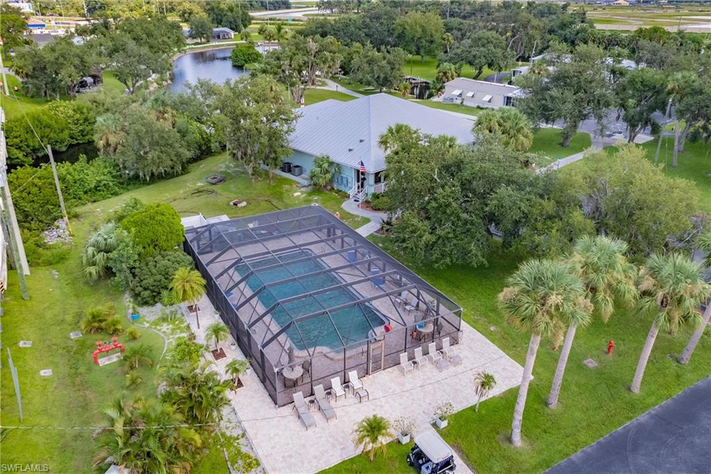 10100 Burnt Store Road, Unit 104 Punta Gorda, FL 33950 - Photo 34 of 46 View of community pool, waterside clubhouse and dockhouse
