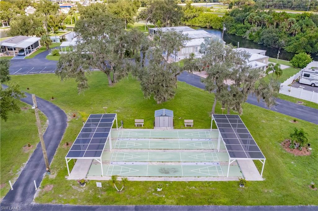 10100 Burnt Store Road, Unit 104 Punta Gorda, FL 33950 - Photo 36 of 46 Drone / aerial view of shuffleboard featuring a water view