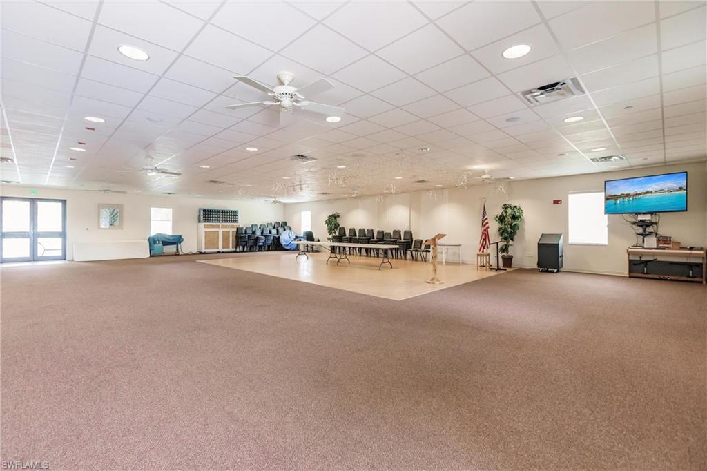 10100 Burnt Store Road, Unit 104 Punta Gorda, FL 33950 - Photo 38 of 46 Haven Hall events center with an outdoor waterside table and seating area