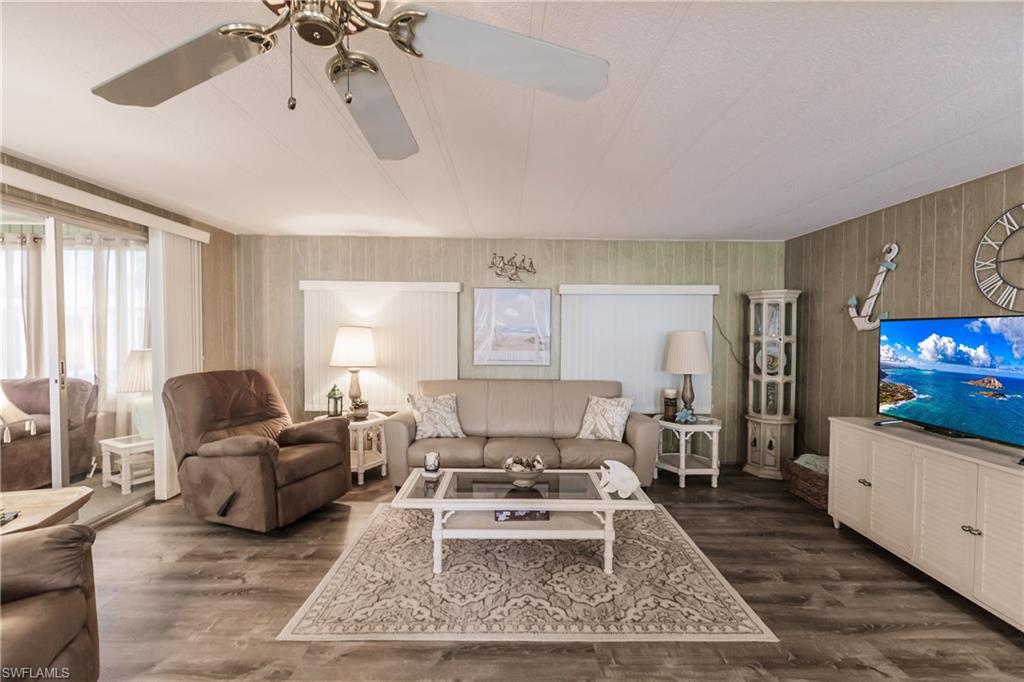 Living room with ceiling fan and luxury vinyl plank flooring