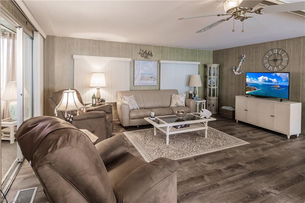 Living room with ceiling fan and luxury vinyl plank flooring