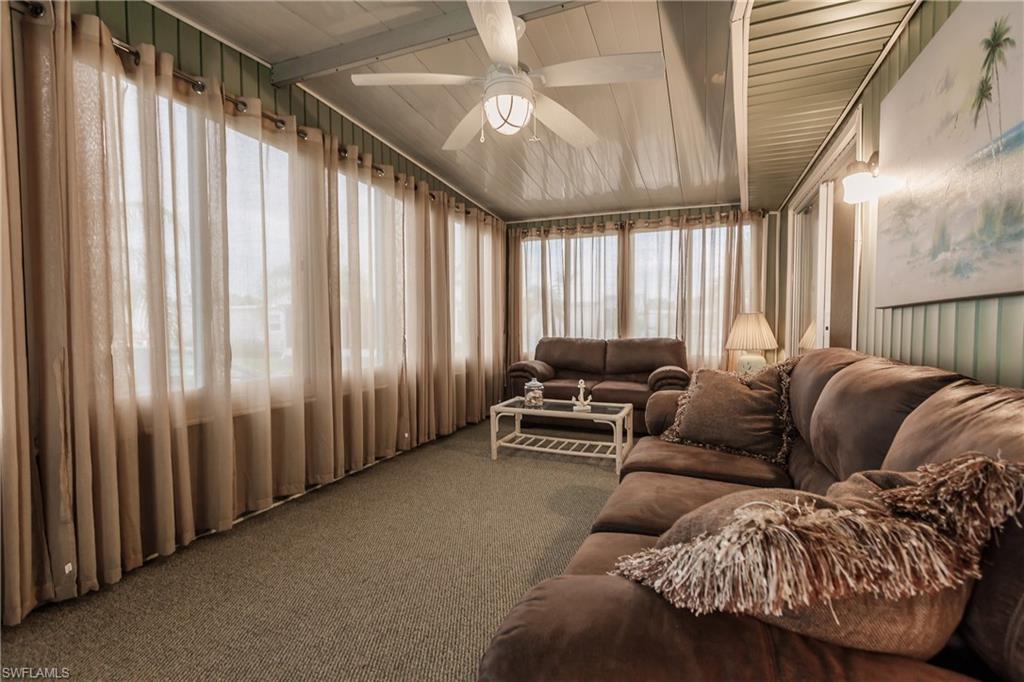 10100 Burnt Store Road, Unit 104 Punta Gorda, FL 33950 - Photo 10 of 46 Sunroom / Florida Room with lofted ceiling with beams and ceiling fan