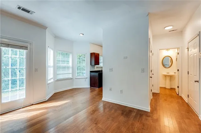 a kitchen with stainless steel appliances a table and chairs in it