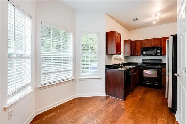 a kitchen with a refrigerator and a sink