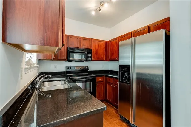 a kitchen with a sink a stove and a refrigerator