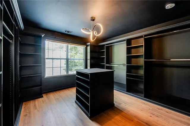 a kitchen with a refrigerator and a chandelier