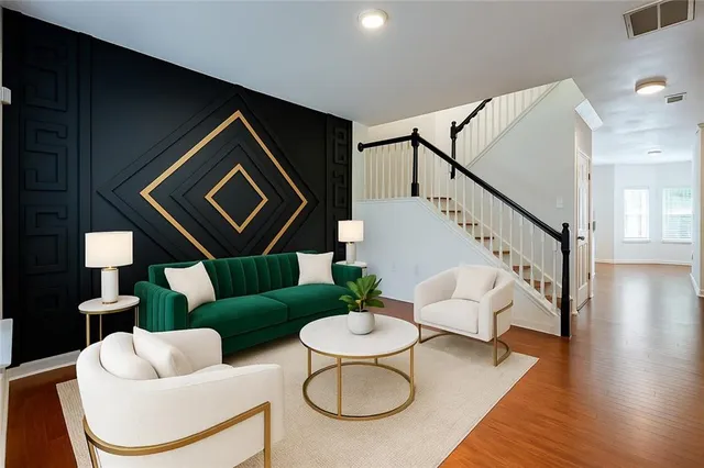 a living room with couches and a dining table with wooden floor