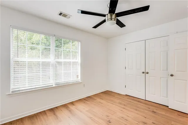 two couches and a potted plant in front of a house