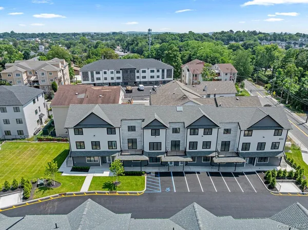 a aerial view of a house with swimming pool lawn chairs and a fire pit