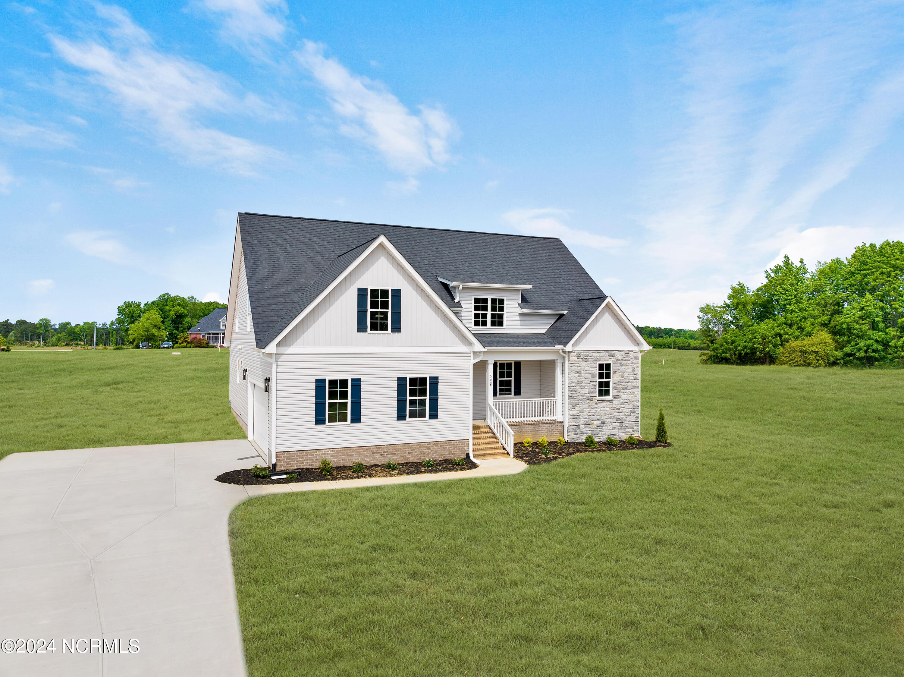 Photo has been enhanced to show the yards potential by adding green lawn.