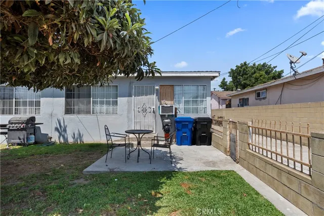 a view of a house with backyard and sitting area
