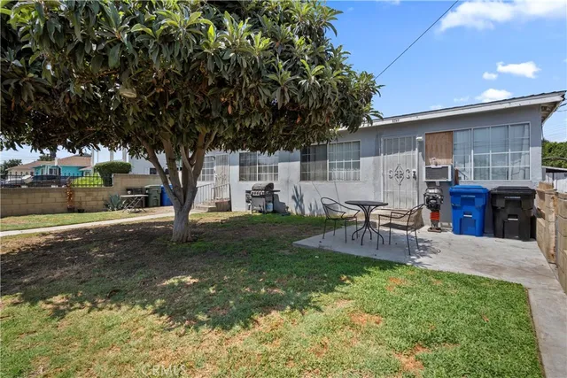 a view of backyard of house with outdoor seating