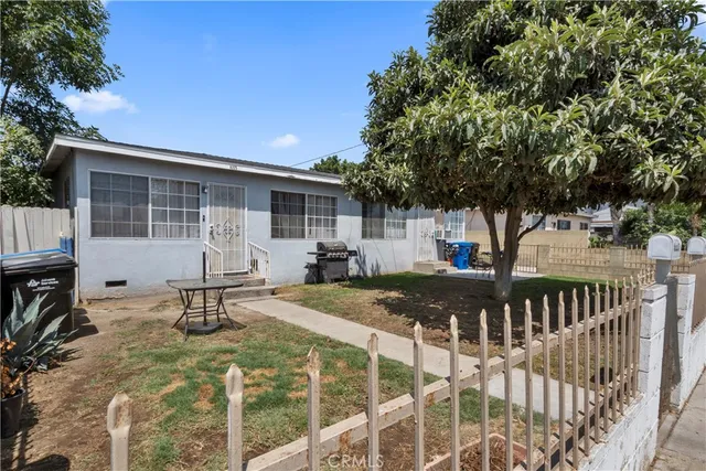 a view of a house with backyard and sitting area