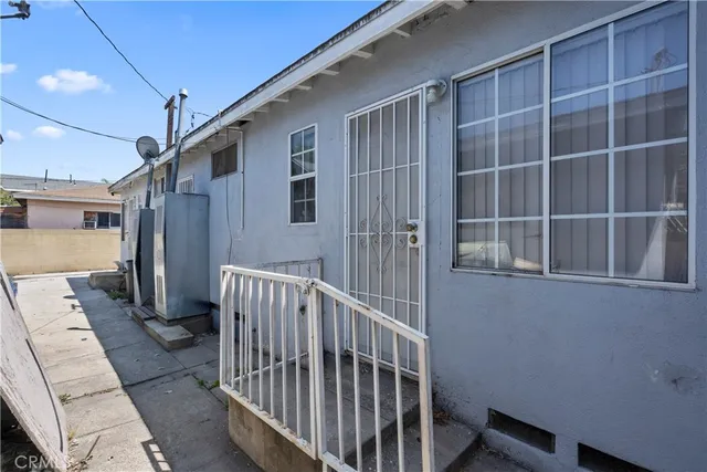 a view of a hallway with a dining table and chairs