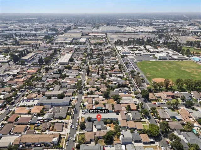 an aerial view of residential houses with city view